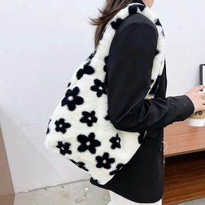 Close-up of a plush floral tote bag with soft faux fur texture and black-white pattern
