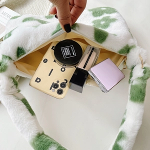 Detail of plush floral handbag showing internal storage for cosmetics and essentials