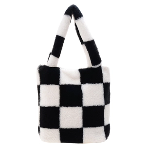 Detail of checkered plush tote bag showing soft faux fur texture and black white pattern