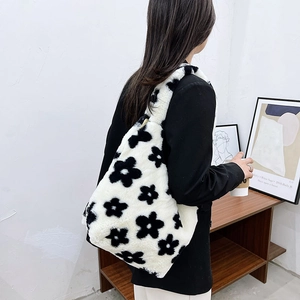 Detailed view of plush daisy patterned shoulder bag made of thick faux fur material