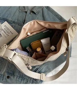 Macro shot showing beige quilted shoulder bag interior with large storage capacity