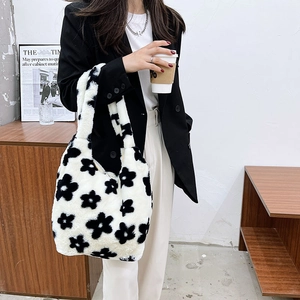 Detailed view of the soft black and white plush floral tote bag texture and design