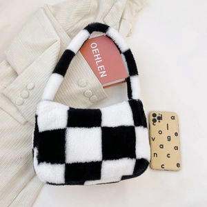 Close-up of plush black and white checkerboard handbag with soft texture detail