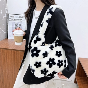 Detailed texture of black floral plush tote bag with soft faux fur shoulder strap