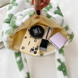 Macro shot of plush tote bag interior with magnetic clasp and makeup storage space