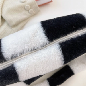 Detail of the soft faux fur texture and black and white striped pattern of the bag