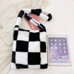 Detailed close-up of plush black and white checkered tote bag with soft fuzzy texture