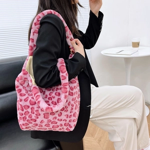 Detail of pink leopard print plush tote bag showing soft faux fur texture on shoulder