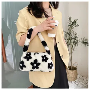 Chic fuzzy black and white floral shoulder bag styled with a stylish yellow suit outfit