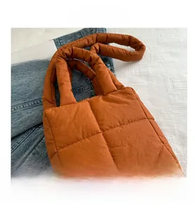 Top view of puffer tote bag in quilted orange brown nylon with soft square patterns