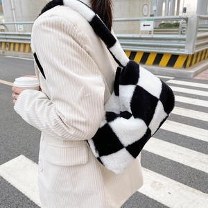 Detail of checkered plush tote bag texture with black and white faux fur material