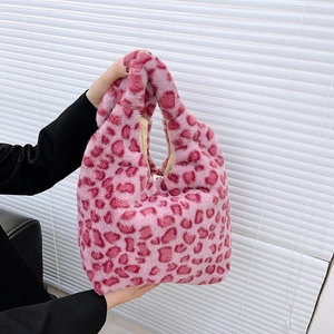 Close-up of pink leopard faux fur tote bag with soft plush texture and matching handle
