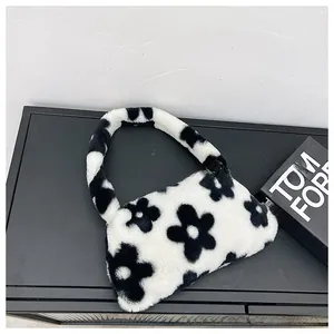 Detail shot of the plush faux fur underarm bag featuring a black and white daisy pattern