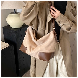 Detailed view of large hobo bag with contrast faux suede and dark brown leather corners
