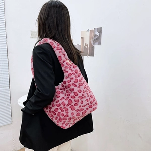 Detail view of pink leopard print plush shoulder bag showing its soft faux fur texture
