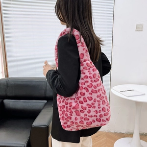 Detail of the soft pink and burgundy leopard print plush tote bag with furry texture