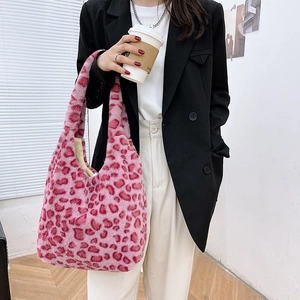 Close-up of pink leopard faux fur tote bag with wide shoulder strap and fluffy texture