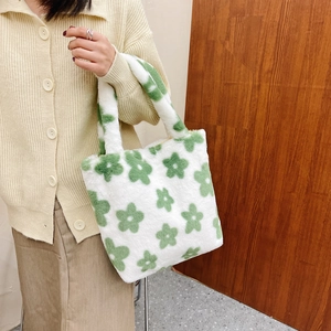 Detail of soft plush tote bag with green floral pattern and thick handles