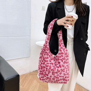 Close-up of pink leopard print plush shoulder bag with soft faux fur texture