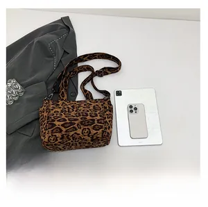 Flat lay of retro leopard print tote bag with tablet and blazer for size reference