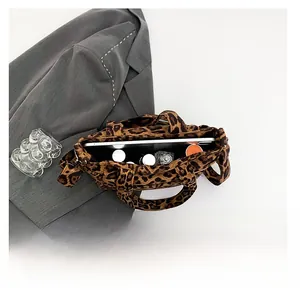 Spacious interior of leopard print tote bag holding a tablet and cosmetics