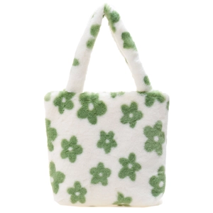 Macro detail of plush faux fur texture on white tote bag with green floral pattern