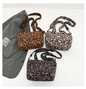 Three leopard print canvas tote bags in brown, beige, and grey with shoulder straps