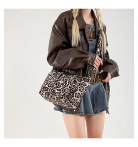 Detail of vintage leopard print tote bag featuring textured canvas and adjustable strap