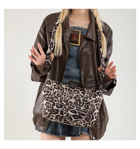 Detail view of stylish leopard print tote bag with wide strap and silver metal hardware