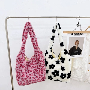 Detail view of plush leopard and floral tote bags hanging in a cozy boutique setting