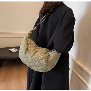Close-up of quilted olive green hobo bag with detailed stitching and silver zipper