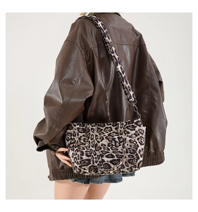 Detail of leopard print tote bag with adjustable wide shoulder strap and metal hooks