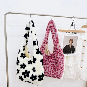 Detail of plush hobo bag with soft faux fur texture and floral or leopard patterns