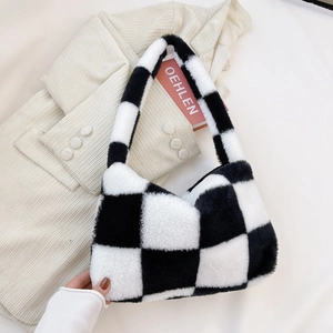 Detail of black and white checkerboard plush handbag with soft faux fur texture