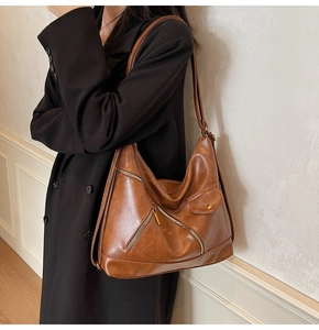 Detailed view of the large brown PU leather tote bag with stylish metal zipper pocket