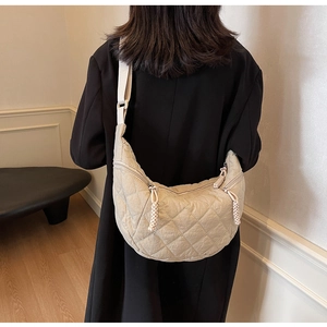 Detail of beige quilted shoulder bag featuring premium diamond stitching and large capacity