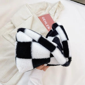 Detail shot of black and white checkerboard plush headband with soft fuzzy texture