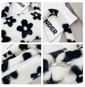 Close-up of plush floral shoulder bag showing soft faux fur texture and white zipper detail