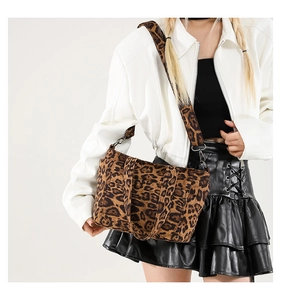 Chic leopard print tote bag styled as a crossbody on a model with white jacket