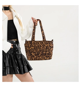 Detailed view of the leopard print tote bag with reinforced handles and metallic D-rings