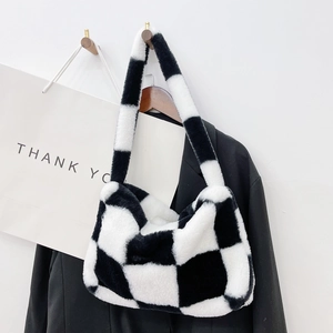 Detail of soft black and white checkerboard plush handbag with fuzzy faux fur texture