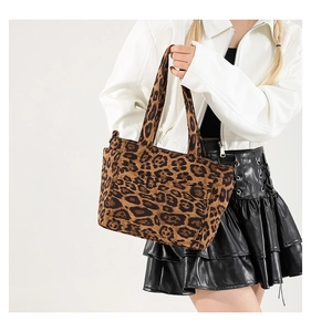 Detailed view of leopard print tote bag with soft faux fur texture and twin handles