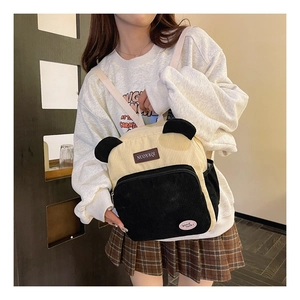 Close-up of corduroy panda backpack detail with 3D ears and durable black zipper pockets