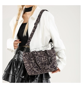 Detail of vintage leopard print tote with wide adjustable strap on a female model