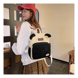 Detail of cute panda-style corduroy backpack featuring animal ears and logo patch