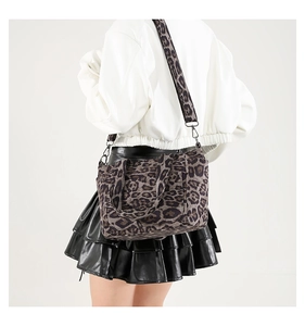 Detail of leopard print tote bag with wide shoulder strap and durable fabric texture