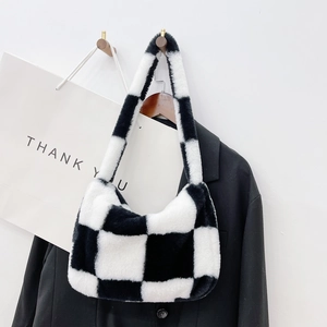 Detail of checkered plush handbag with soft faux fur texture for autumn and winter style