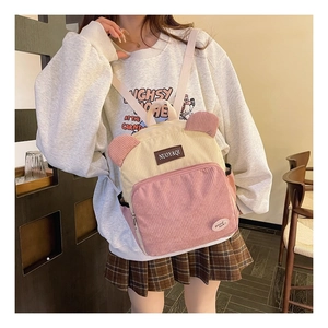 Close-up of the corduroy backpack showing cute ear decorations and pink accents