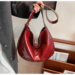 Detail of glossy deep red PU leather Hobo bag with wide fabric shoulder strap