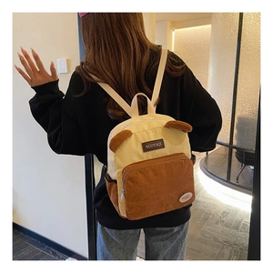 Detail view of corduroy backpack with cute bear ears in beige and brown tones